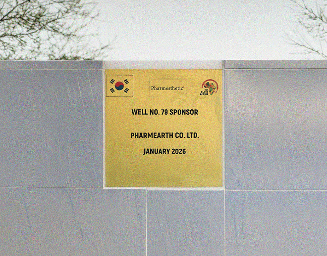 A brass plaque reading “Well No. 79 Sponsor, Pharmearth Co. Ltd., January 2026” mounted on the well wall beside a Korean flag